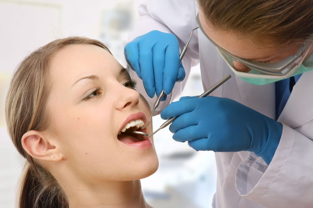 стоматолог проводит осмотр зубов