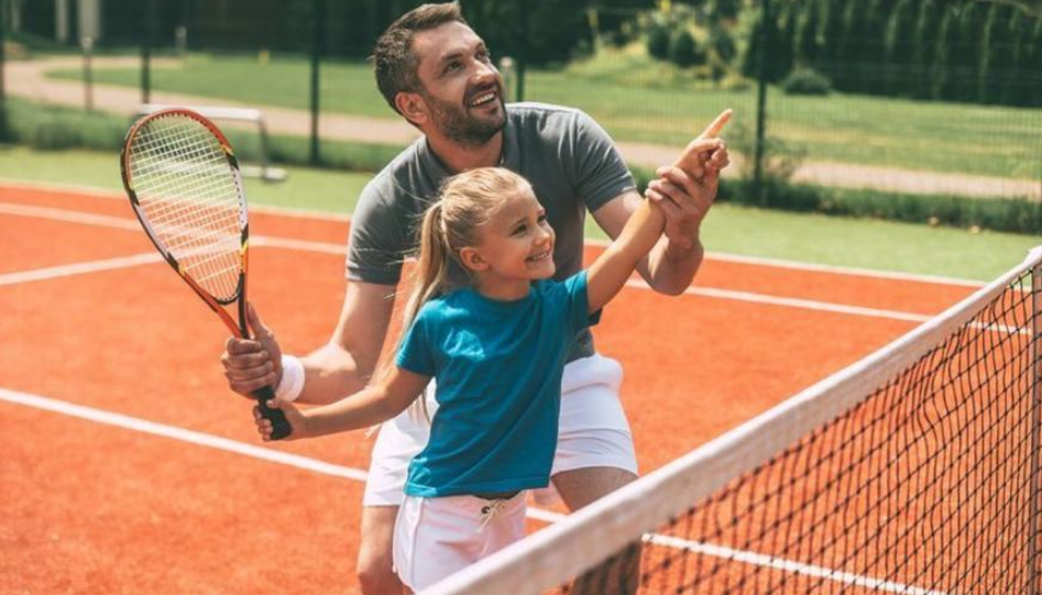 Процесс обучения игры в теннис: папа и дочь
